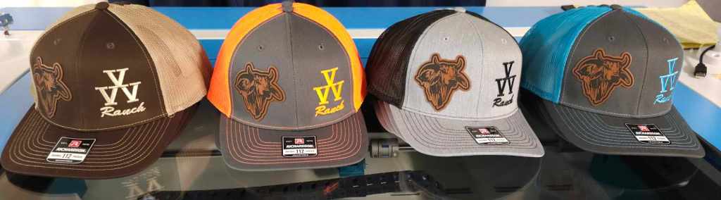 Four different leatherette patch caps displayed on a flat surface, each with distinct colors and the 'VV Ranch' logo.